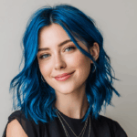 Smiling woman with vibrant electric blue hair coloured using Smart Beauty Electric Blue Hair Dye with Plex Care – vegan, cruelty-free semi-permanent hair colour made in the UK for bold, salon-quality results.