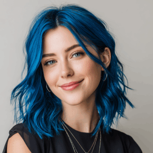 Smiling woman with vibrant electric blue hair coloured using Smart Beauty Electric Blue Hair Dye with Plex Care – vegan, cruelty-free semi-permanent hair colour made in the UK for bold, salon-quality results.